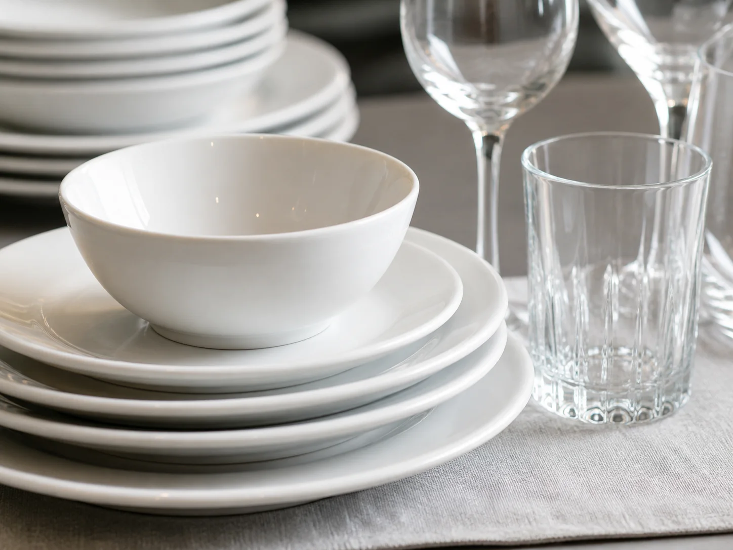 Close-up of hotel ceramic dinnerware and clear glassware materials