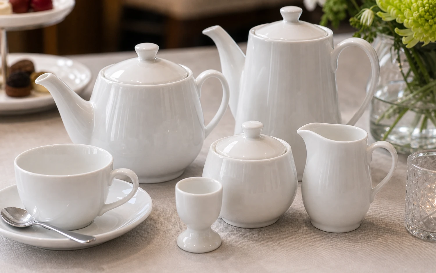 Close-up of white porcelain tea service with cup and saucer