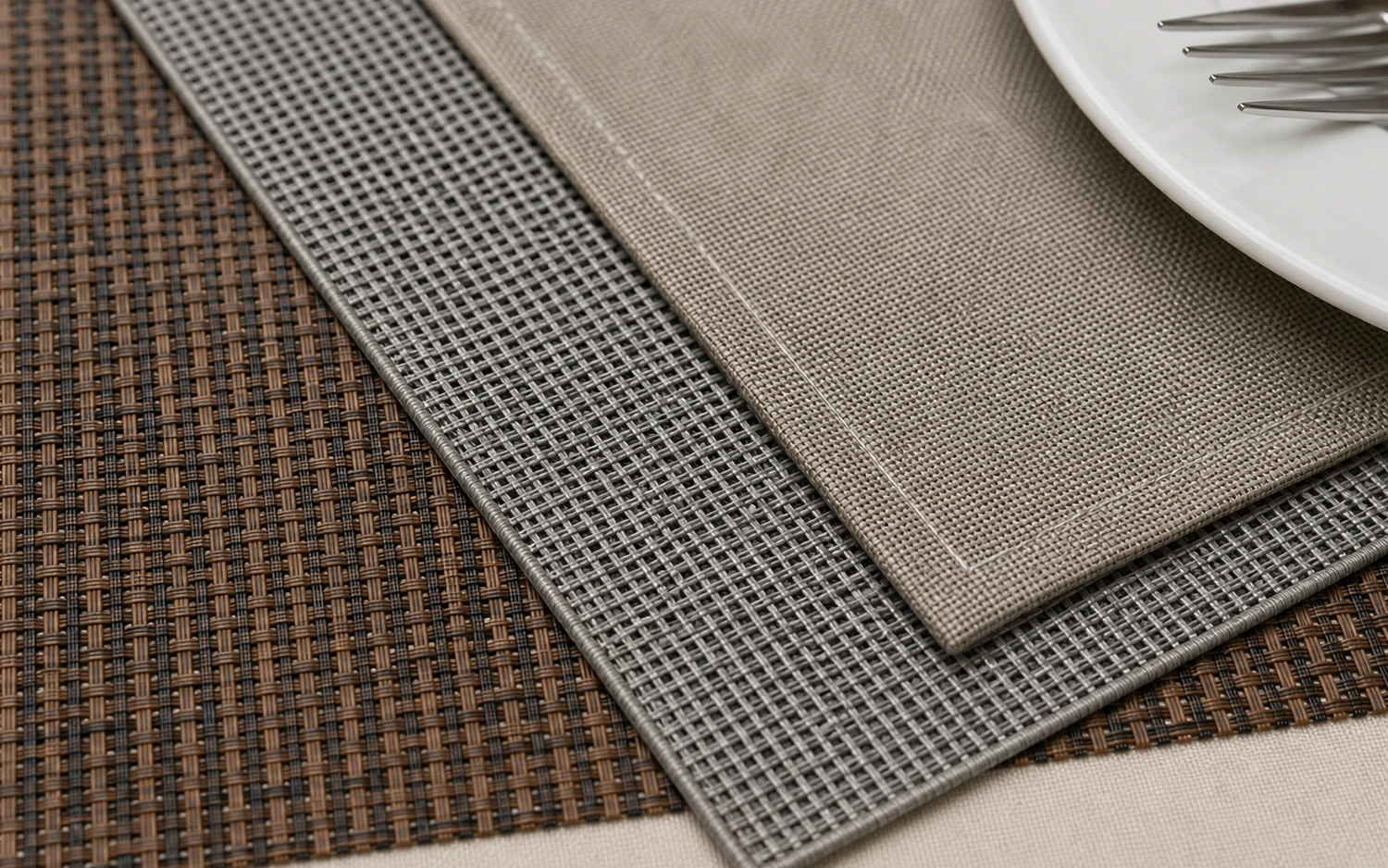 Close-up of woven placemat texture and layered table setting materials
