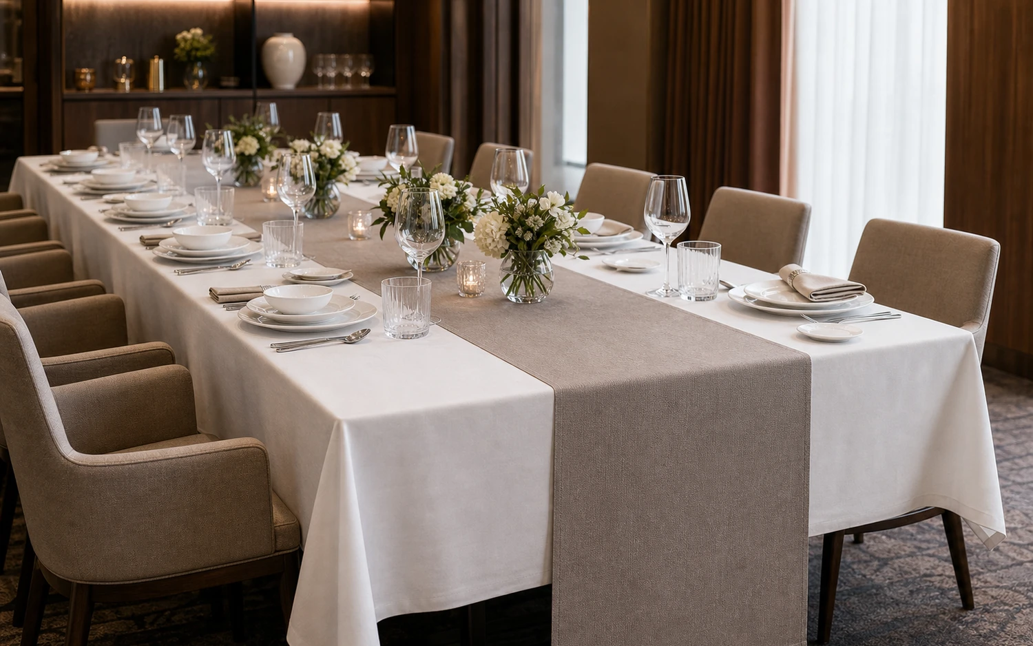 Layered restaurant place setting on a dark table runner