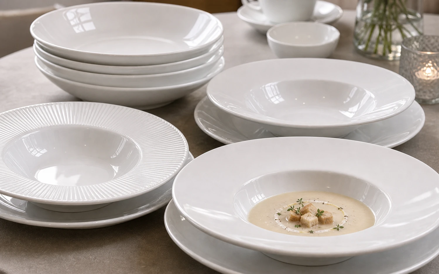 Close-up of white porcelain soup plate with bowl and cup service pieces