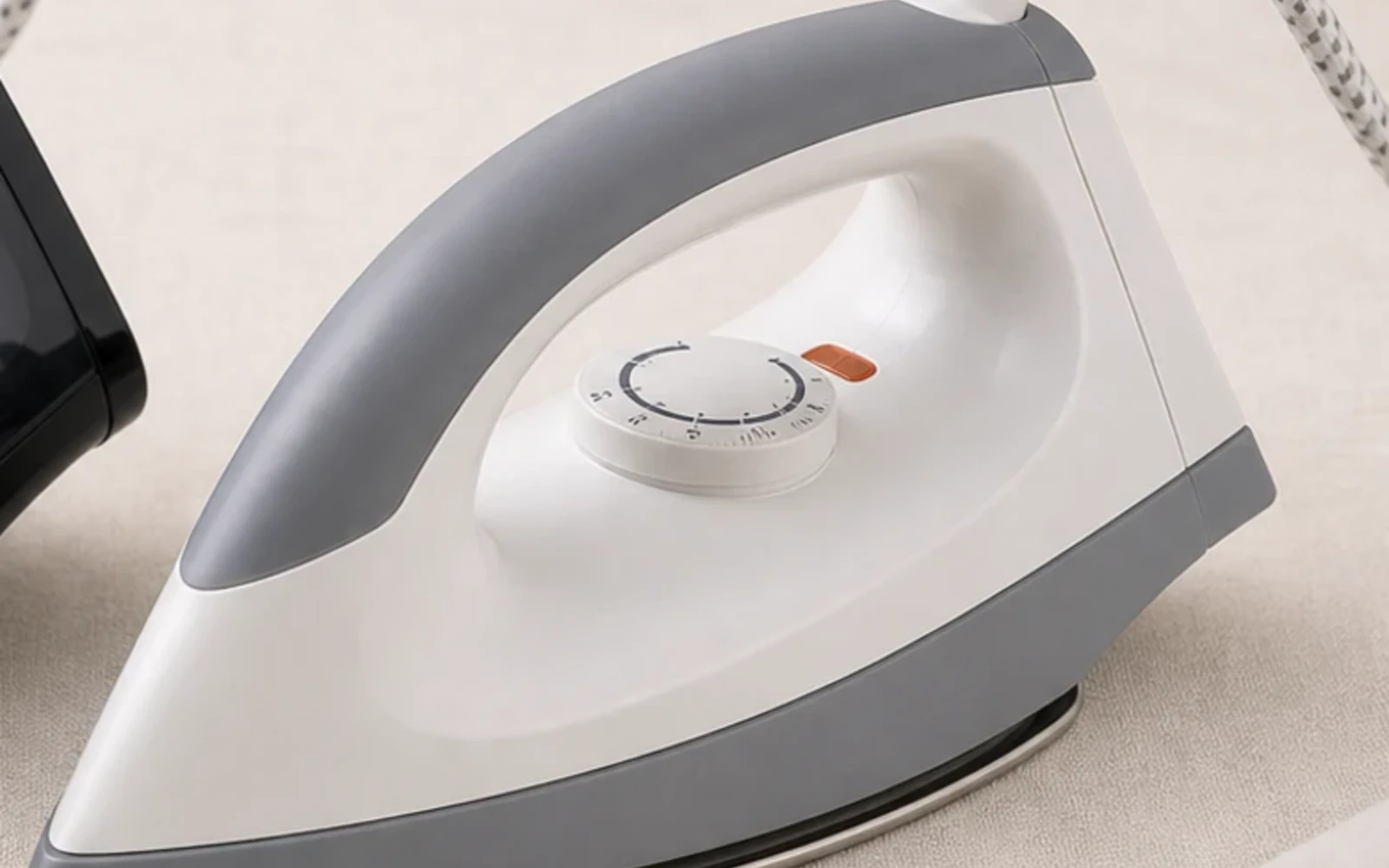 White and grey hotel steam iron with transparent water tank