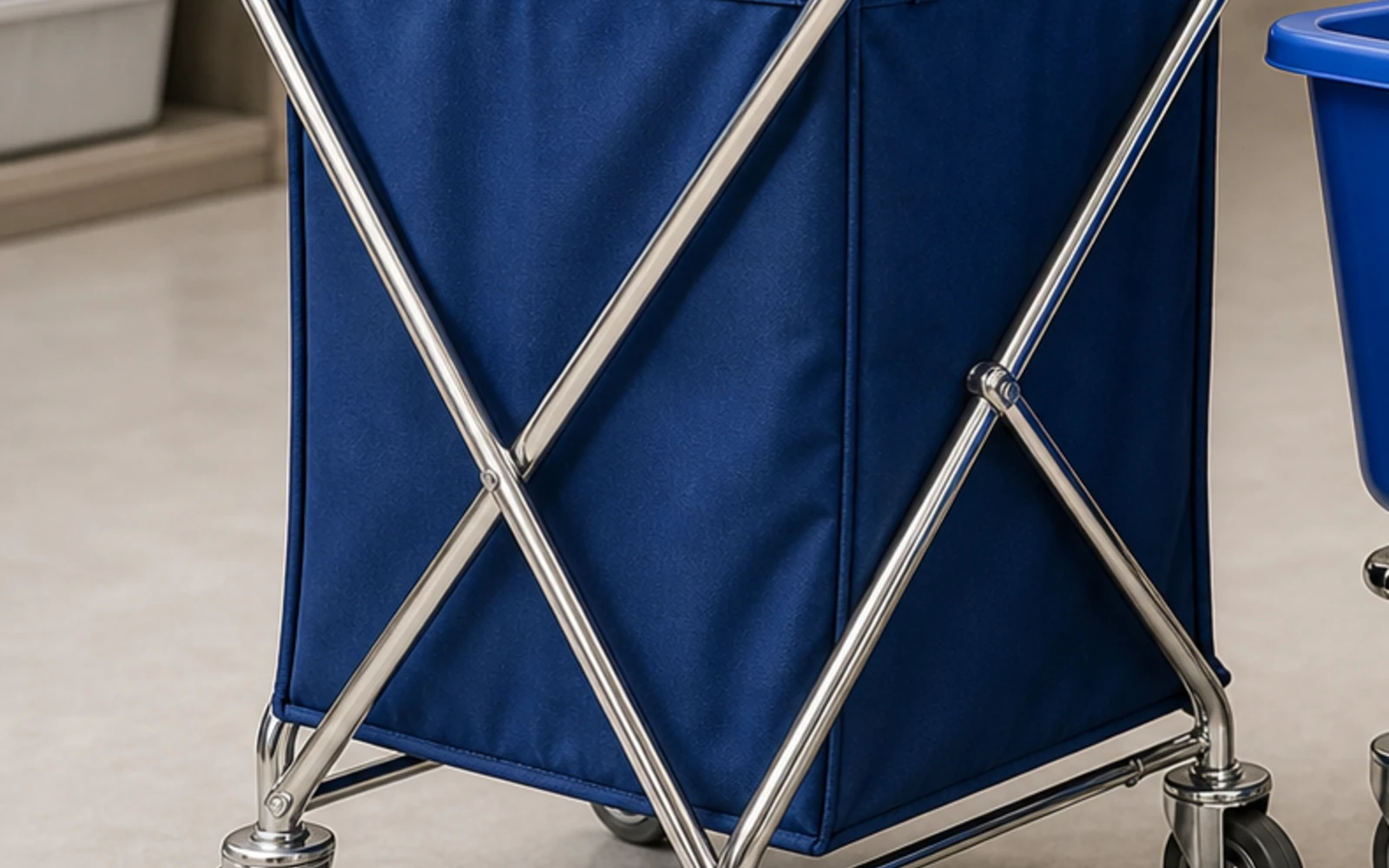 Folding X-frame hotel laundry cart with blue fabric bag